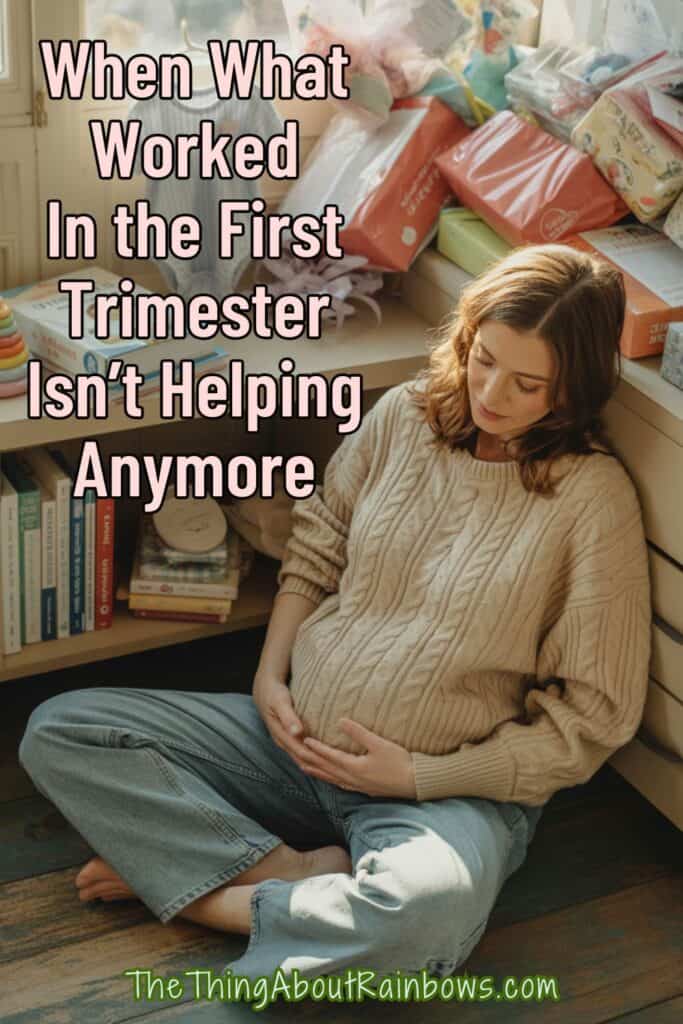 Pregnant woman surrounded by baby items, looking down with emotion, highlighting changing prep patterns since the first trimester.